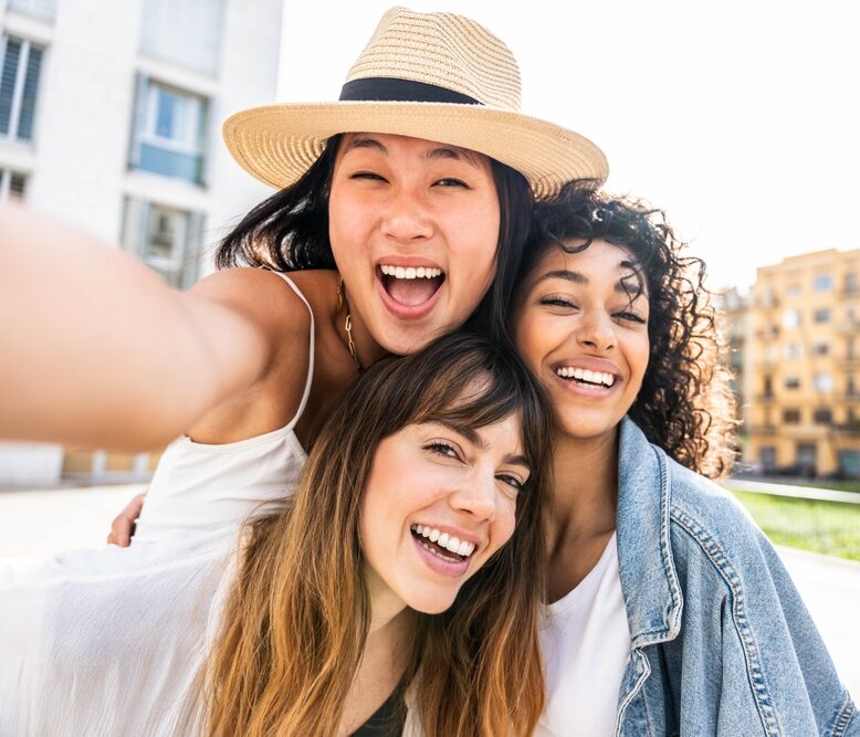 Smiling friends taking a selfie outdoors